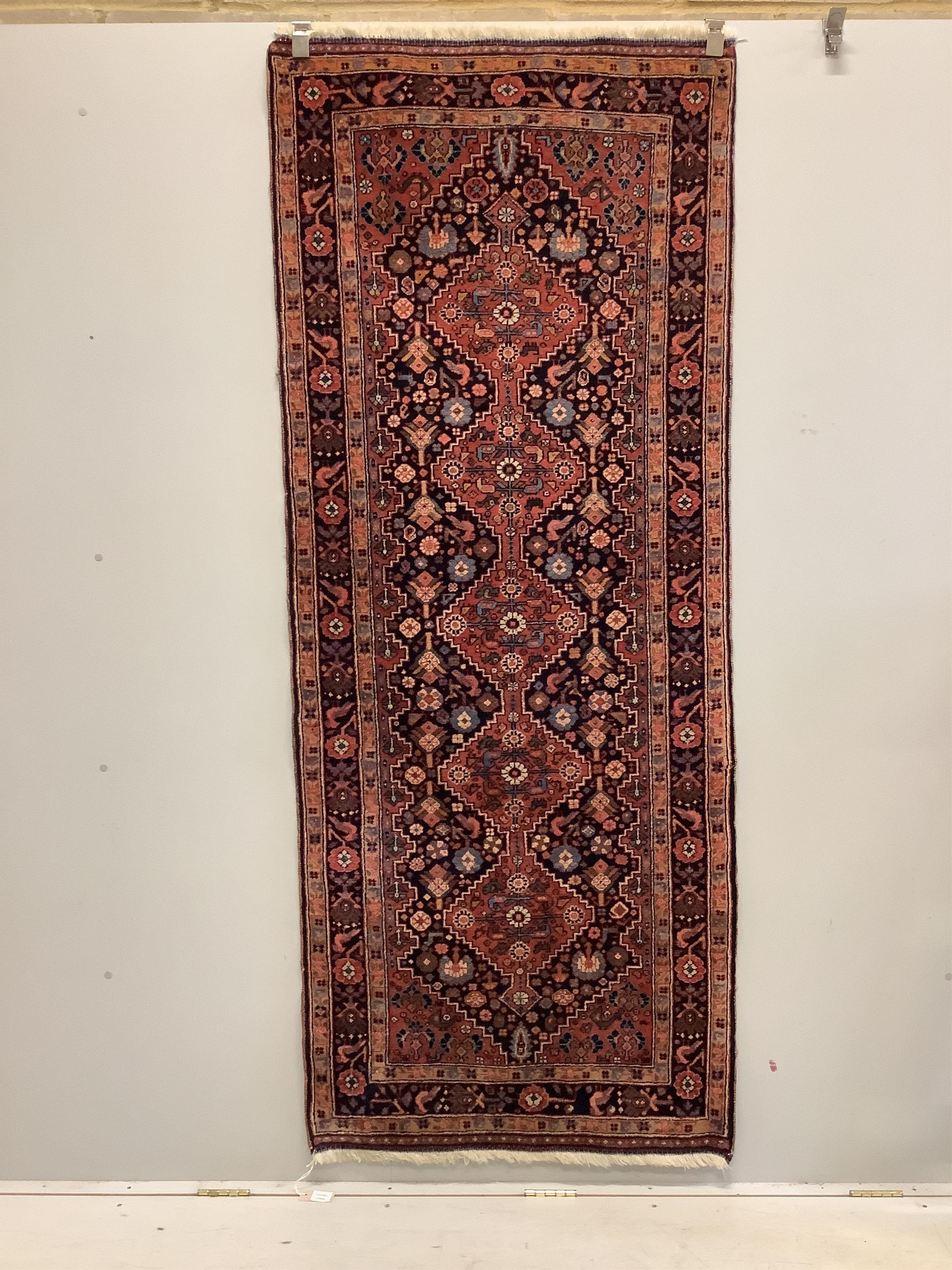 A Caucasian red ground runner, woven a central row of lozenges, 222 x 90cm. Condition - good